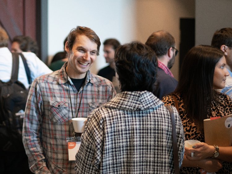 Man laughing while conversing
