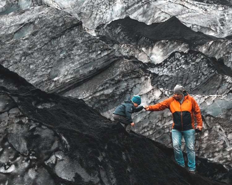 Man and child climbing on rocks